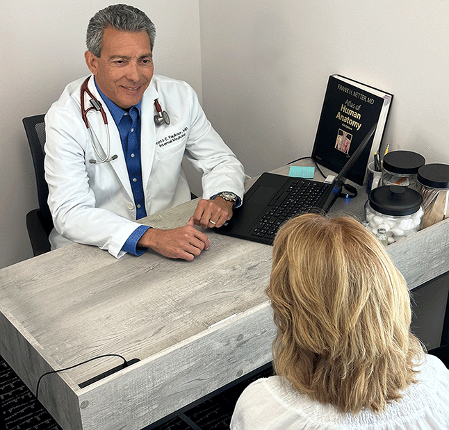 Image of Dr. Faulkner meeting with a patient